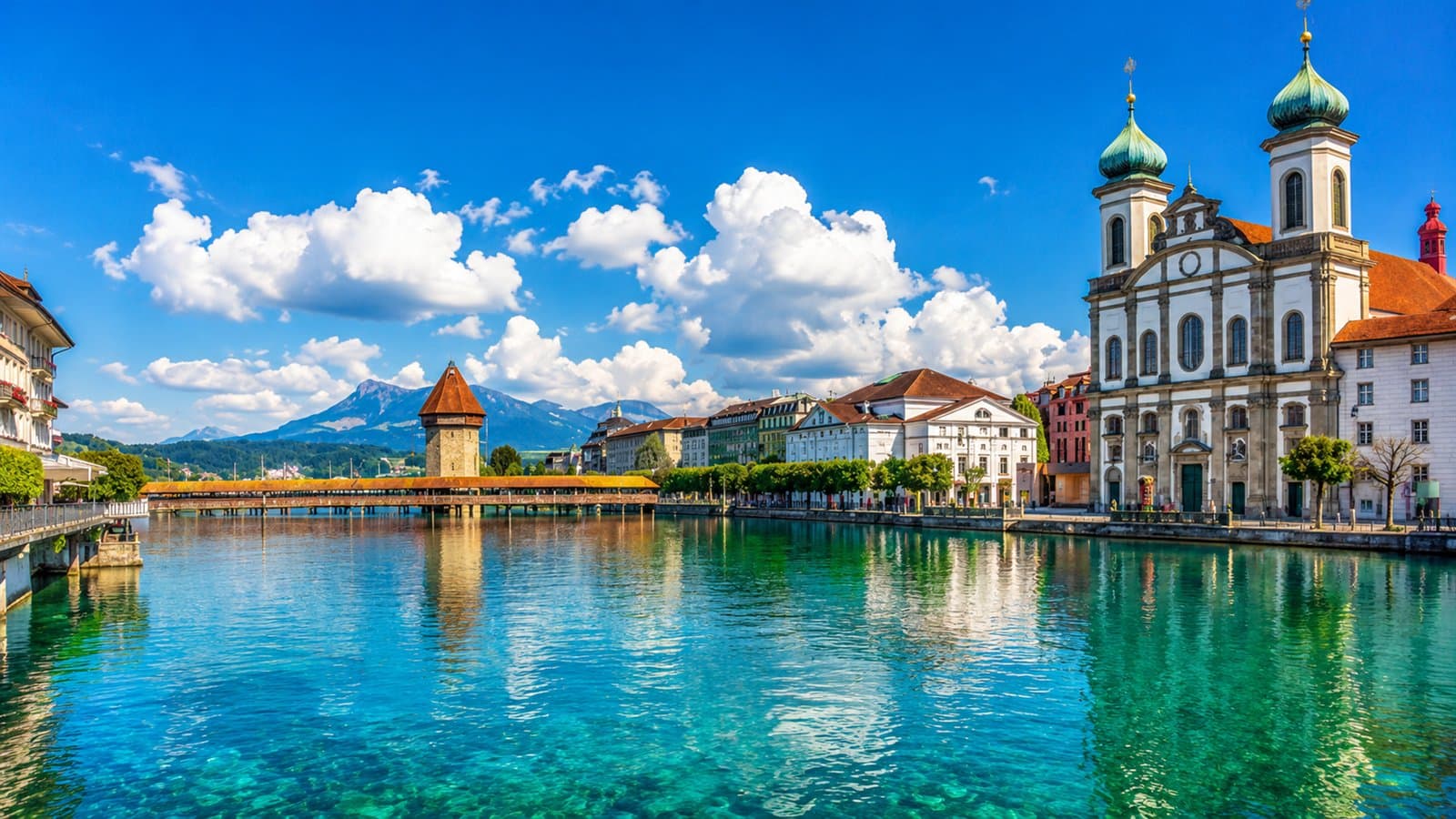 Lucerne old town with the Kapellbrücke wooden bridge and the Jesuit church reflected in the Reuss river
